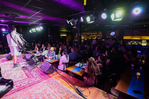 A vibrant live music performance captured in a cozy, bustling club atmosphere.